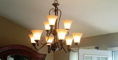Classic ceiling chandelier installation with warm lighting in Tucson, AZ