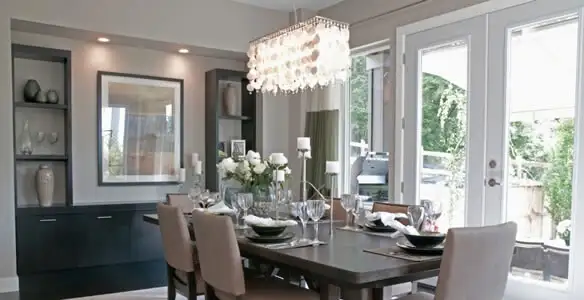 Elegant dining room chandelier installation above table in Tucson, AZ