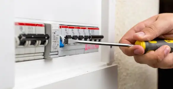 electrical panel upgrade service showing technician adjusting circuit breakers during system upgrade in Tucson, AZ