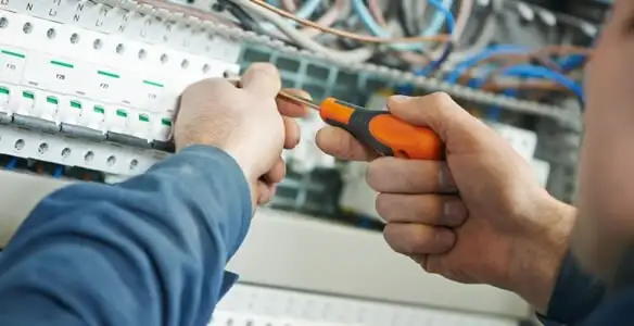 electrical service showing licensed electrician performing electrical panel maintenance and adjustments in Tucson, AZ