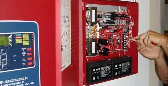 fire alarm installation service showing technician configuring fire alarm control panel in Tucson, AZ