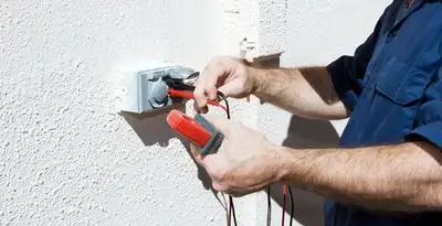 Electrician performing home electrical outlet and wiring inspection in Tucson, AZ