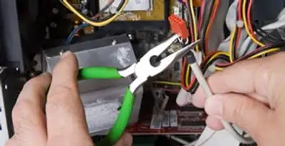 Licensed electrical contractor performing electrical repair with tools in Sahuarita, AZ