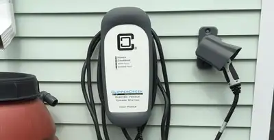 Outdoor electric vehicle charger installation on residential wall in Tucson, AZ