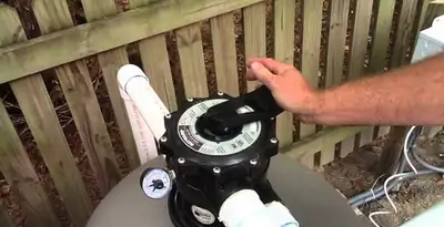 pool pumps service showing professional adjustment of pool pump control system in Tucson, AZ